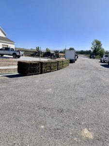 Pallets of sod sitting on the side of the road ready to be unrolled into a lawn for a new house.