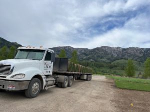 A flatbed semi truck loaded with sod.