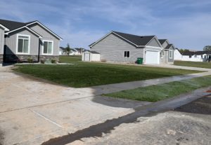 A house with a freshly watered sod lawn.